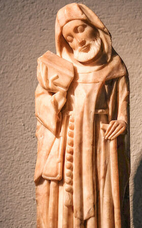 "Holding a shovel in one hand, Saint Fiacre is presented as the patron saint of gardeners. According to the legend of this seventh-century saint, Fiacre earned the right to establish a hermitage and a hospice for the poor after single-handedly clearing an entire forest in one day. Famed for growing many different kinds of vegetables and herbs in his garden in Meaux, France, he made and dispensed many herbal remedies. Credited with miraculous cures, Saint Fiacre was particularly renowned for curing hemorrhoids."