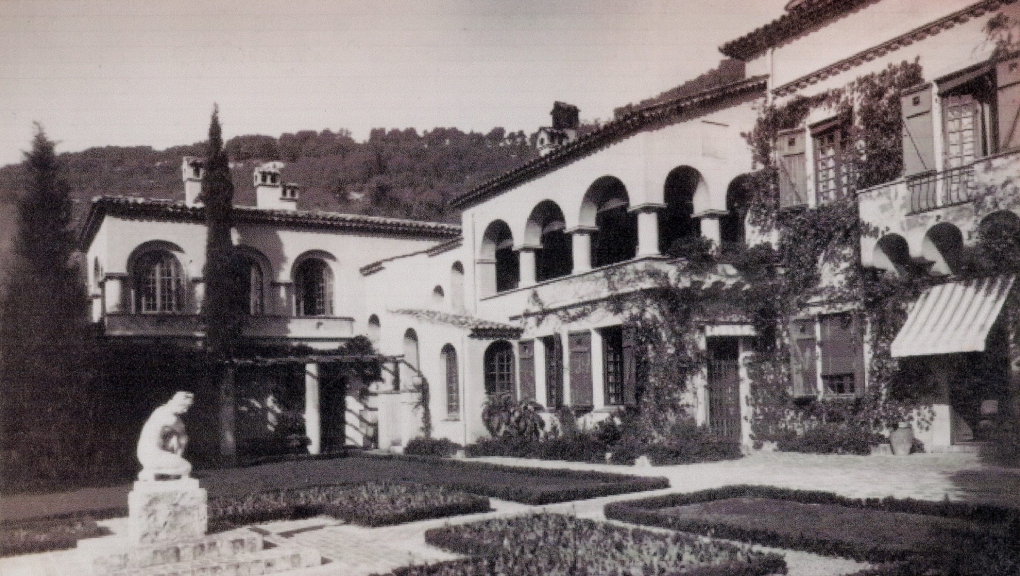 Vue historique de la villa Val Rahmeh à Menton, avec son architecture méditerranéenne et son jardin structuré, ornée d’une statue.